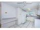 The well-lit kitchen is equipped with white appliances, functional workspace, and white cabinets at 9101 86Th Ave, Seminole, FL 33777