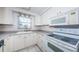 Clean kitchen with ample cabinet space and appliances, tiled floor, and natural light at 9101 86Th Ave, Seminole, FL 33777