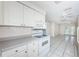 Open-concept kitchen, white cabinets, tiled flooring, view of the living space at 9101 86Th Ave, Seminole, FL 33777