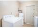 Functional laundry area featuring a washing machine and water heater at 9101 86Th Ave, Seminole, FL 33777