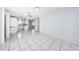 Open-concept living space connecting to the kitchen, with tile flooring throughout at 9101 86Th Ave, Seminole, FL 33777