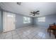 Inviting living room with tile flooring, natural light, and a traditional ceiling fan at 9101 86Th Ave, Seminole, FL 33777