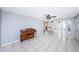 View of the living room leading to the kitchen, with tile flooring and a piano at 9101 86Th Ave, Seminole, FL 33777
