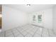 Bright living room featuring white walls, tiled floors, and glass doors leading to the outside at 9101 86Th Ave, Seminole, FL 33777