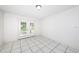 Bright living room featuring white walls, tiled floors, and glass doors leading to the outside at 9101 86Th Ave, Seminole, FL 33777