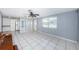 Bright living room showcasing tile flooring, open layout and seamless flow to the kitchen at 9101 86Th Ave, Seminole, FL 33777