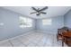 Large living room featuring tile flooring, two windows, and a ceiling fan at 9101 86Th Ave, Seminole, FL 33777