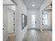 Bright hallway with tile floors, white walls, and doorways, leading to various rooms in the home at 10388 Sun Isle Dr, Englewood, FL 34223