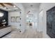 Bright hallway featuring light wood floors and views into the office and living room at 10388 Sun Isle Dr, Englewood, FL 34223