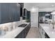 Modern kitchen with navy cabinets, white countertops, herringbone backsplash, and stainless steel appliances at 10388 Sun Isle Dr, Englewood, FL 34223