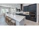 Modern open kitchen featuring navy cabinets, an island with seating, and stainless steel appliances at 10388 Sun Isle Dr, Englewood, FL 34223
