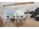 Spacious living room featuring white couches, wood floors, and a dark kitchen in the background at 10388 Sun Isle Dr, Englewood, FL 34223