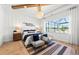 Beautiful main bedroom with decorative lighting, paneled accent wall, and waterfront view at 10388 Sun Isle Dr, Englewood, FL 34223