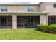 The home's backyard and exterior view of the screened-in patio at 10425 Yellow Spice Ct, Riverview, FL 33578