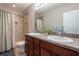 The bathroom features a dual sink vanity and a shower-tub combo with beautiful neutral tiling at 10425 Yellow Spice Ct, Riverview, FL 33578