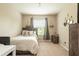 Neutral bedroom offers comfort and style with a plush bed, soft carpet, and serene ambiance at 10425 Yellow Spice Ct, Riverview, FL 33578