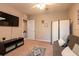 This bonus room provides a cozy space with a comfortable sofa and entertainment setup for relaxation at 10425 Yellow Spice Ct, Riverview, FL 33578