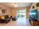 Comfortable living room with tile floors, natural light, and a view of the screened lanai at 10425 Yellow Spice Ct, Riverview, FL 33578