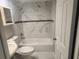 Updated bathroom features tub/shower combo with decorative tile and new fixtures at 11715 Salmon Dr, Port Richey, FL 34668
