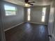 Bedroom with multiple windows allowing for natural light and wood-look flooring at 11715 Salmon Dr, Port Richey, FL 34668