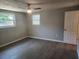 Bedroom with multiple windows allowing for natural light and wood-look flooring at 11715 Salmon Dr, Port Richey, FL 34668