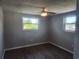 Bedroom with multiple windows allowing for natural light and wood-look flooring at 11715 Salmon Dr, Port Richey, FL 34668