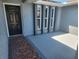 Covered entryway boasting unique architectural details and stylish black front door at 11715 Salmon Dr, Port Richey, FL 34668