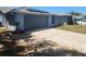 Charming single-story home featuring a two-car garage, solar panels, and a well-maintained lawn at 11715 Salmon Dr, Port Richey, FL 34668
