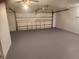 Clean garage featuring a painted floor, and a white paneled garage door with opener at 11715 Salmon Dr, Port Richey, FL 34668