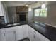 Beautiful kitchen with granite counters, stainless appliances, and a stone fireplace in view at 11715 Salmon Dr, Port Richey, FL 34668