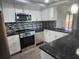 Modern kitchen showcasing granite countertops, stainless steel appliances, and tile backsplash at 11715 Salmon Dr, Port Richey, FL 34668