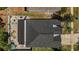 Birds-eye view of home highlighting backyard brick patio, fire pit, and roof at 13215 Beechberry Dr, Riverview, FL 33579