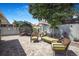 Landscaped backyard with a patio, comfortable seating, and lush greenery, perfect for outdoor living at 13215 Beechberry Dr, Riverview, FL 33579