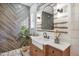 Stylish bathroom featuring wood-look herringbone tile and modern fixtures at 13215 Beechberry Dr, Riverview, FL 33579