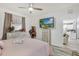 Comfortable bedroom features a TV, neutral color palette, and access to other rooms at 13215 Beechberry Dr, Riverview, FL 33579