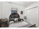 Cozy bedroom features a unique headboard, modern decor, and a comfortable bed at 13215 Beechberry Dr, Riverview, FL 33579