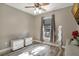 Serene bedroom with wood-look floors, a ceiling fan, and natural light from the window at 13215 Beechberry Dr, Riverview, FL 33579