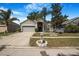 Charming single-Gathering home featuring a well-manicured lawn, mature trees, and a two-car garage in a quiet neighborhood at 13215 Beechberry Dr, Riverview, FL 33579