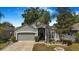 Attractive single-Gathering home with a well-kept lawn, mature landscaping, and a two-car garage enhancing curb appeal at 13215 Beechberry Dr, Riverview, FL 33579