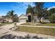 Inviting single-Gathering home with a lush front yard, palm trees, and a two-car garage adding to the neighborhood's charm at 13215 Beechberry Dr, Riverview, FL 33579