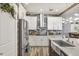 Beautiful kitchen with white cabinets, stainless steel appliances, and a modern backsplash at 13215 Beechberry Dr, Riverview, FL 33579