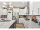 Well-equipped kitchen with white cabinets, granite countertops, and stainless steel appliances at 13215 Beechberry Dr, Riverview, FL 33579