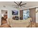 Inviting living room with a comfortable leather sofa, decorative fireplace, barn doors, and stylish tile flooring at 13215 Beechberry Dr, Riverview, FL 33579