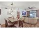 Open-concept living and dining area with modern lighting, wood floors, and a large sectional sofa at 13215 Beechberry Dr, Riverview, FL 33579