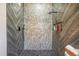 Luxurious walk-in shower with unique tile work and contemporary fixtures, perfect for relaxation at 13215 Beechberry Dr, Riverview, FL 33579
