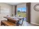 Dining room with wood table and bench seating, sliding glass doors to the patio and a view of the pond at 1421 Brown Mallet Pl, Ruskin, FL 33570