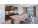 Modern kitchen with dark wood cabinets, granite countertops, stainless appliances, island and adjacent dining area at 1421 Brown Mallet Pl, Ruskin, FL 33570