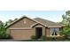 Charming single-story home with a two-car garage and a well-manicured lawn and landscaped garden at 1429 Brown Mallet Pl, Ruskin, FL 33570