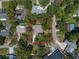 Aerial view of the home showcasing the property lines, mature trees, and lush green surroundings at 1431 Normandy Ln, Palm Harbor, FL 34683