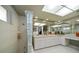 Spacious bathroom with dual sinks, a glass block shower, and ample counter space at 1431 Normandy Ln, Palm Harbor, FL 34683